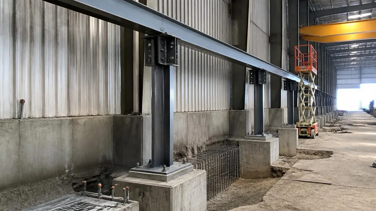 New reinforced concrete foundation and pony column base being installed to support an upgraded crane runway in a plant